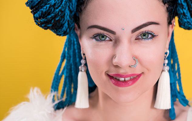 Portrait of a woman with blue eyes and facial piercings