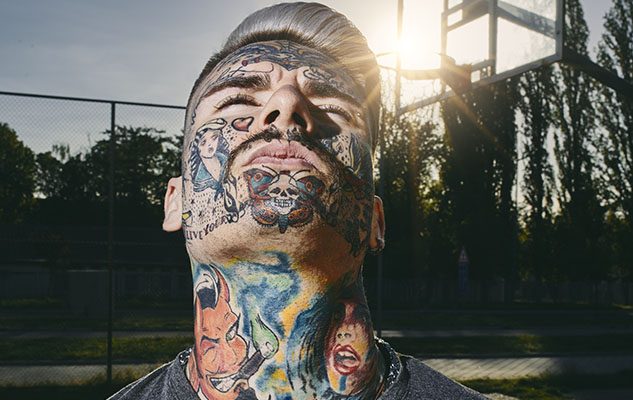 Portrait of tattooed young man on a basketball court