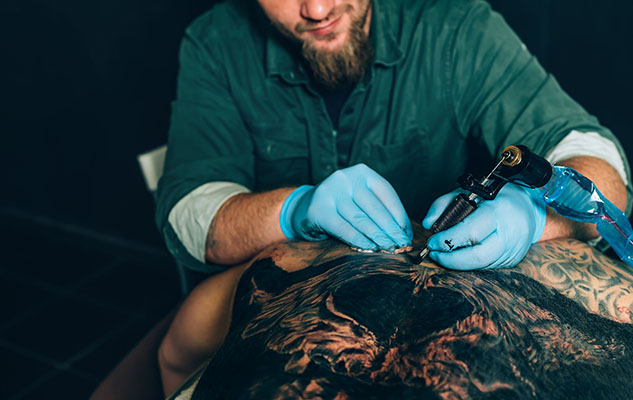 tattoo master makes a closeup tattoo