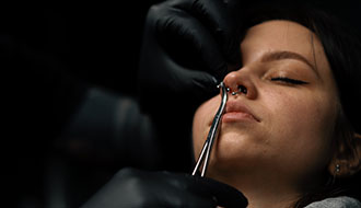 Piercing process on a young girl