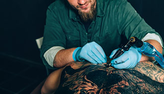 tattoo master makes a closeup tattoo